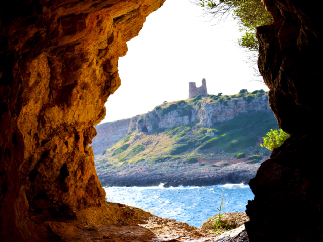 cliff and sea with tower in the distance