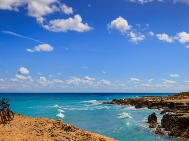 The most beautiful coast of Apulia: Torre Sant' Andrea, Otranto , ITALY (Lecce).Typical coastline of Salento: a pair of bikes for excursions. Seascape with cliffs, rocky arch and sea stacks.